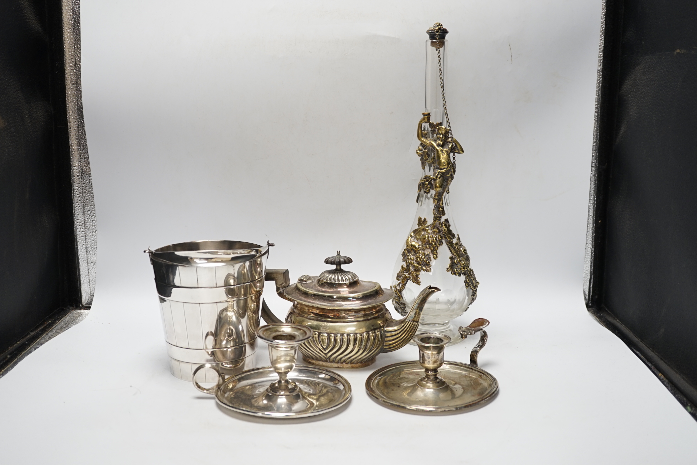 Plated wares: a pair of wine coasters, two ornate basket-edged dishes, a sugar bowl, three candlesticks, three candleholders, a teapot, ice bucket cased serving spoons and a metal mounted glass decanter.